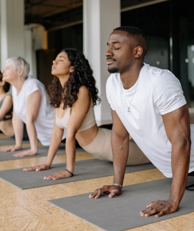 a group of people on yoga mats stetching