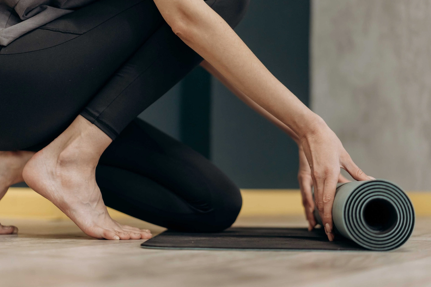 woman rolling out a yoga mat